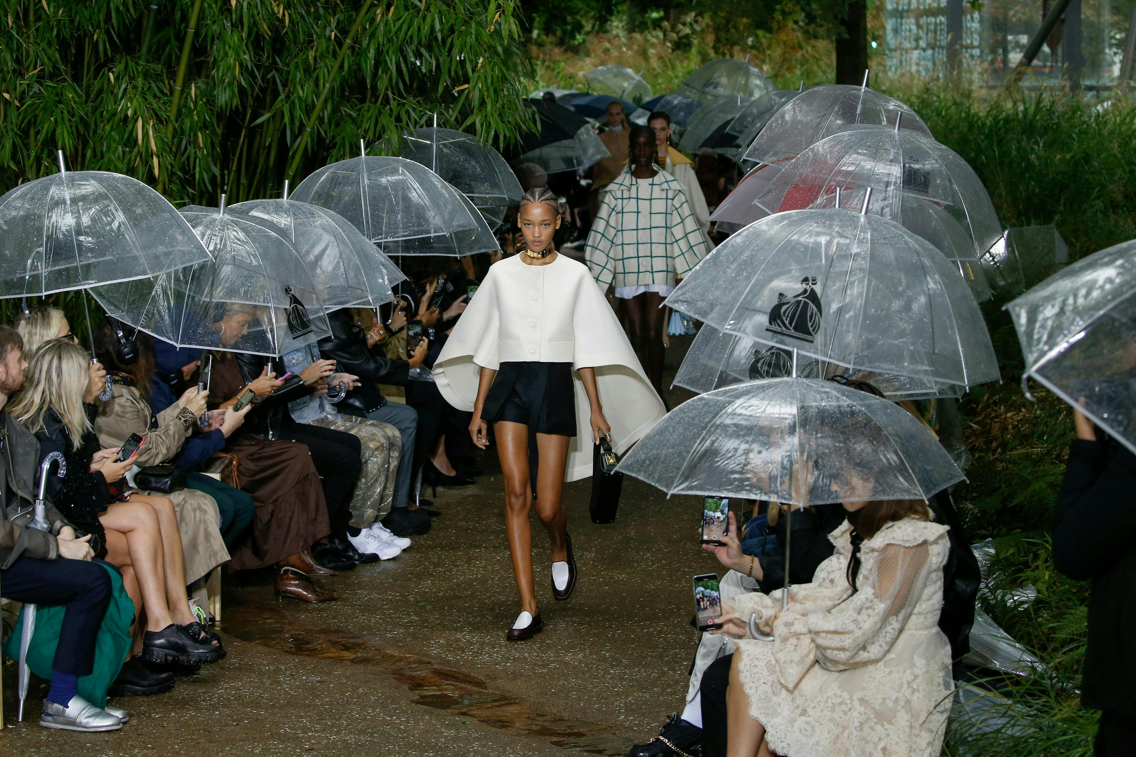 clothing apparel person human shorts umbrella canopy shoe footwear helmet