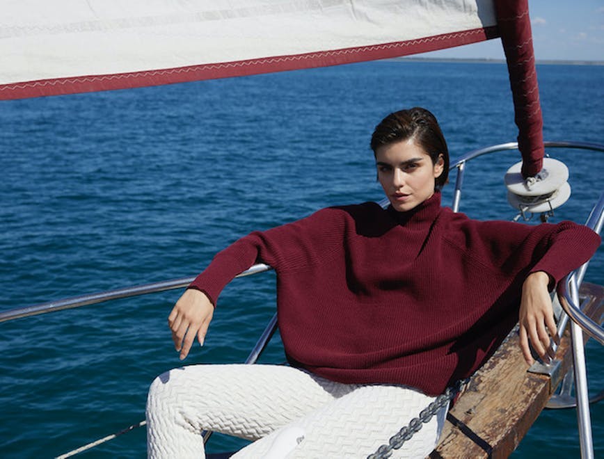 sailboat boat vehicle watercraft person vest clothing lifejacket sweater knitwear