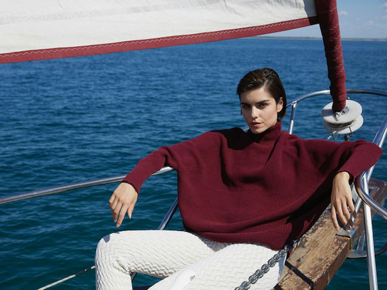 sailboat boat vehicle watercraft person vest clothing lifejacket sweater knitwear
