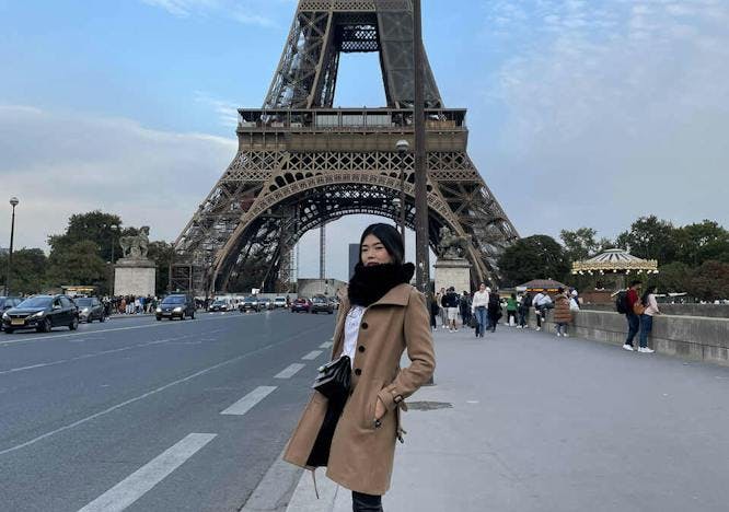architecture building eiffel tower landmark tower clothing coat person