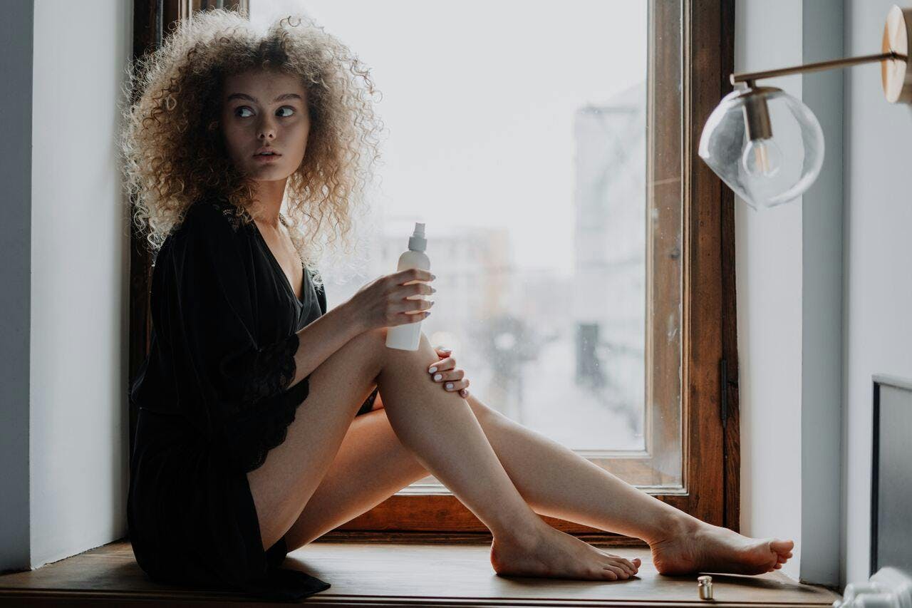 person sitting adult female woman window windowsill shaker hair blonde