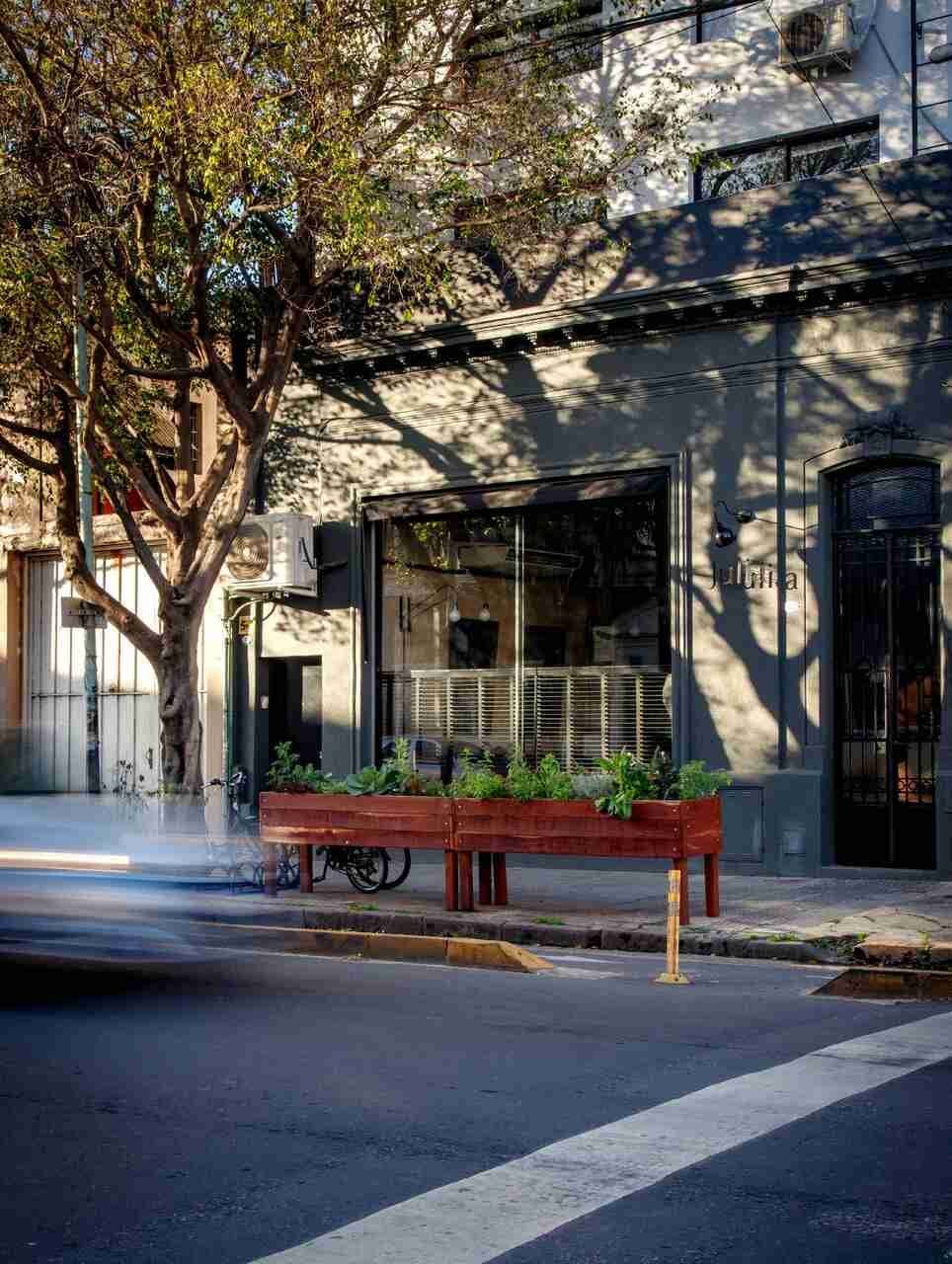 bench furniture city road street urban potted plant neighborhood tarmac path